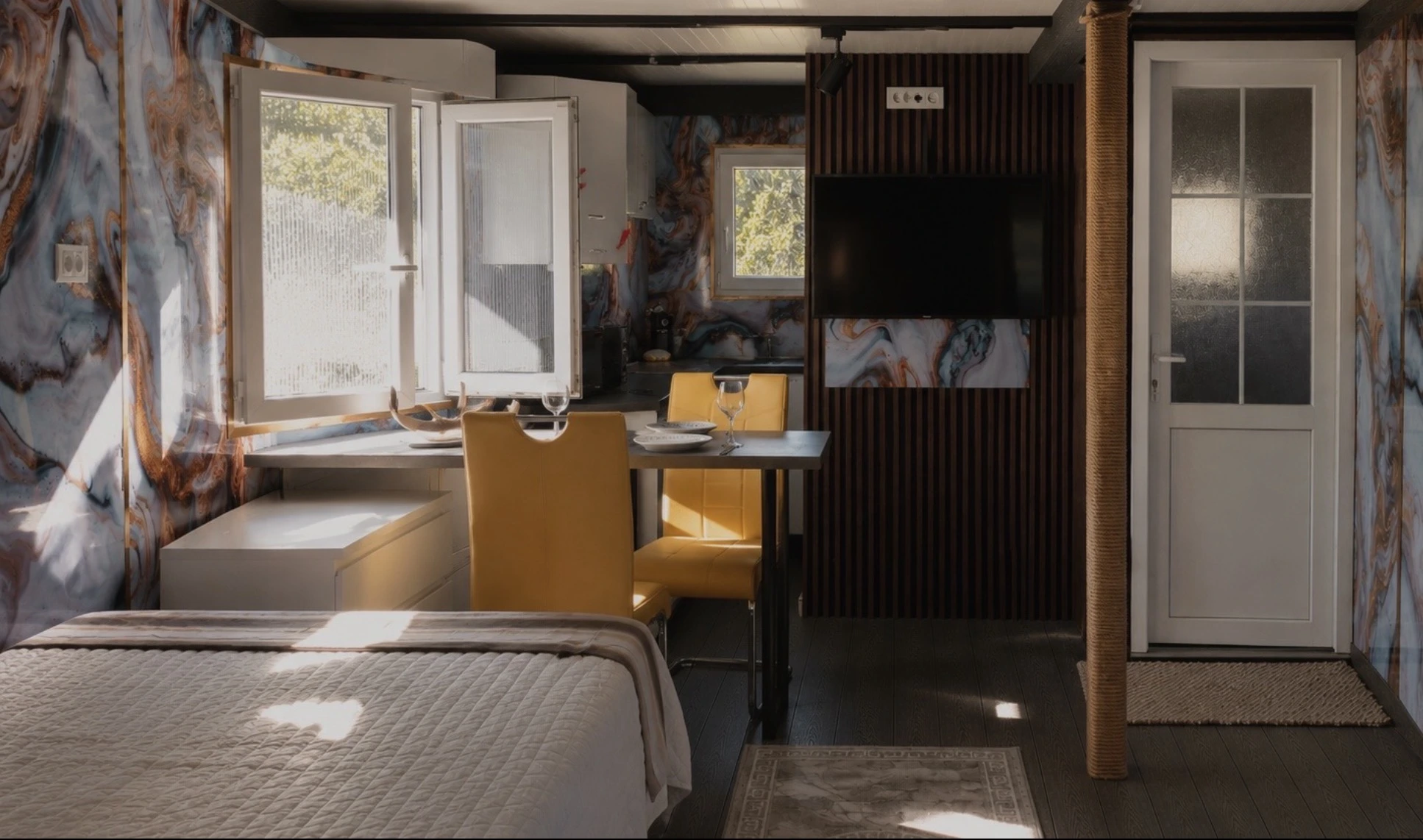 Open-plan sleeping, dining and kitchen area inside an iTiS Villa apartment