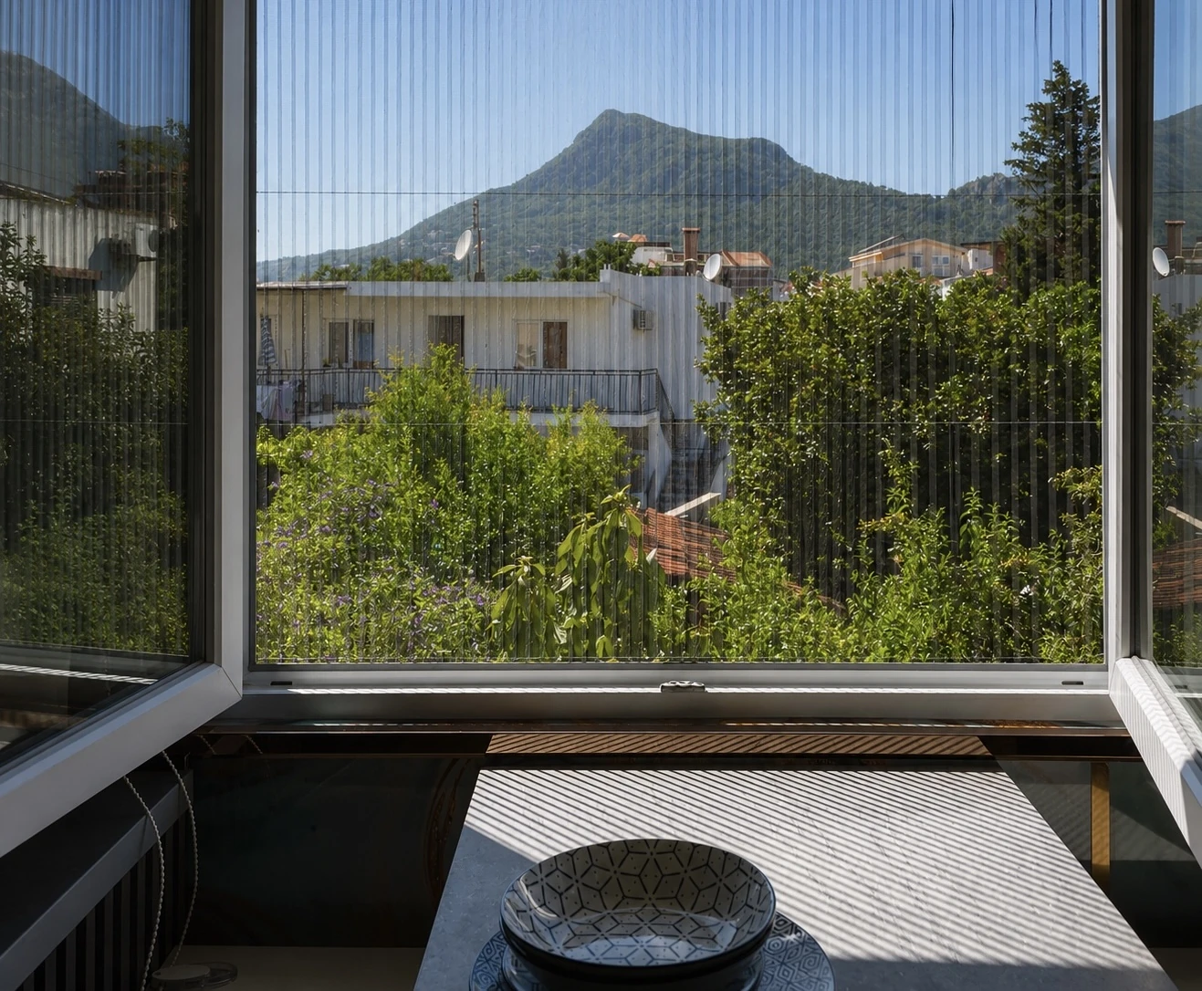 Mountain view through an open apartment window